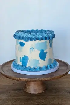 Blue vintage-style buttercream cake on stand